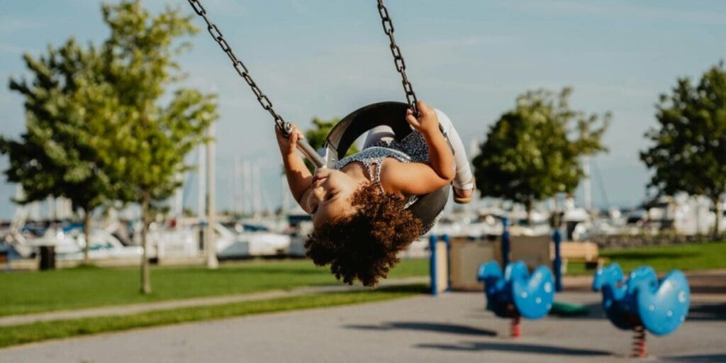 Young Girl Swinging on a Local Playground